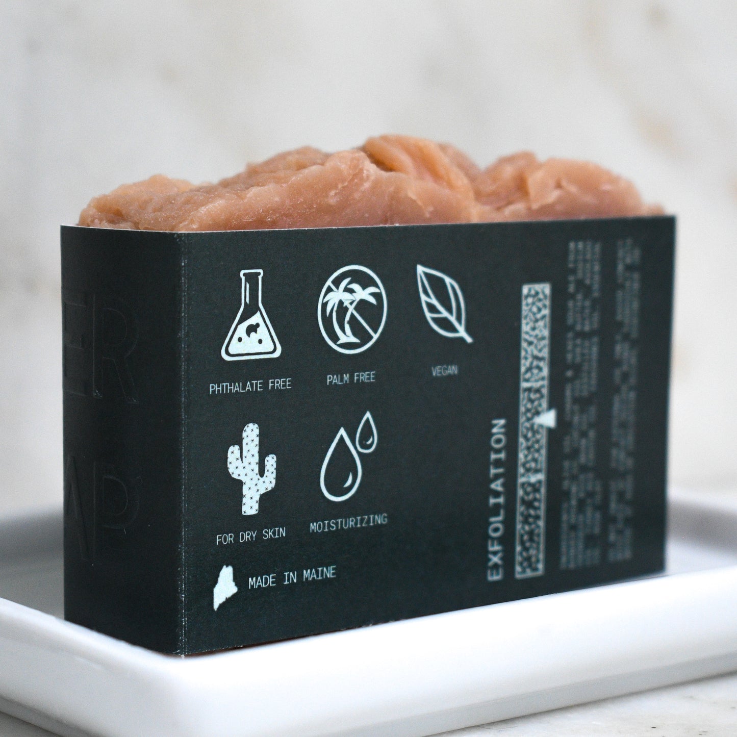 Kettle Rose beer soap on a ceramic soap dish showing on the back label that it is Phthalate free, palm free, vegan, for dry skin, moisturizing, and made in Maine