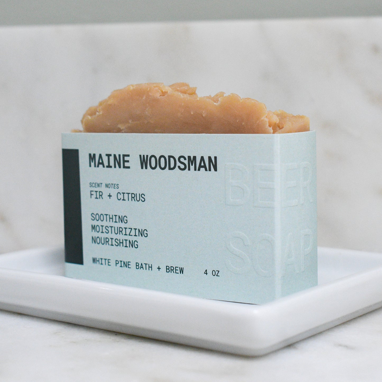 bar of maine woodsman beer soap scented with fir and citrus.