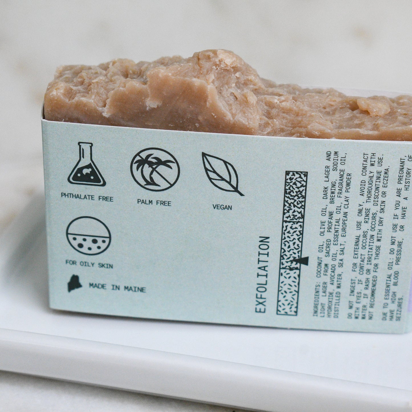 Sea Salt + Clay beer soap scented with rosemary and lavender, stating it is cleansing, exfoliating, and nourishing