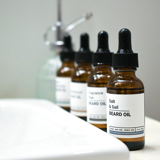 line of four beard oils with salt + Sail in front