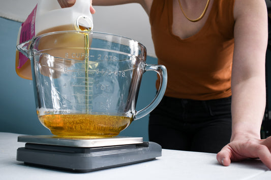 Elaine Kinney pouring oil into measuring cup