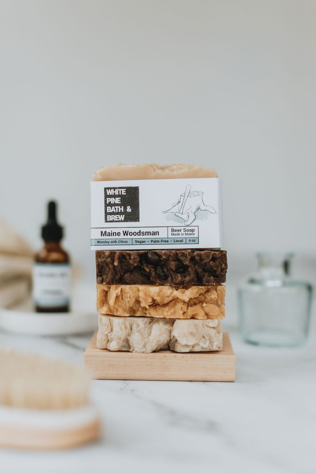 collection of self care items including a bar of vegan, beer soap called Sea Salt & Clay by White Pine Bath & Brew