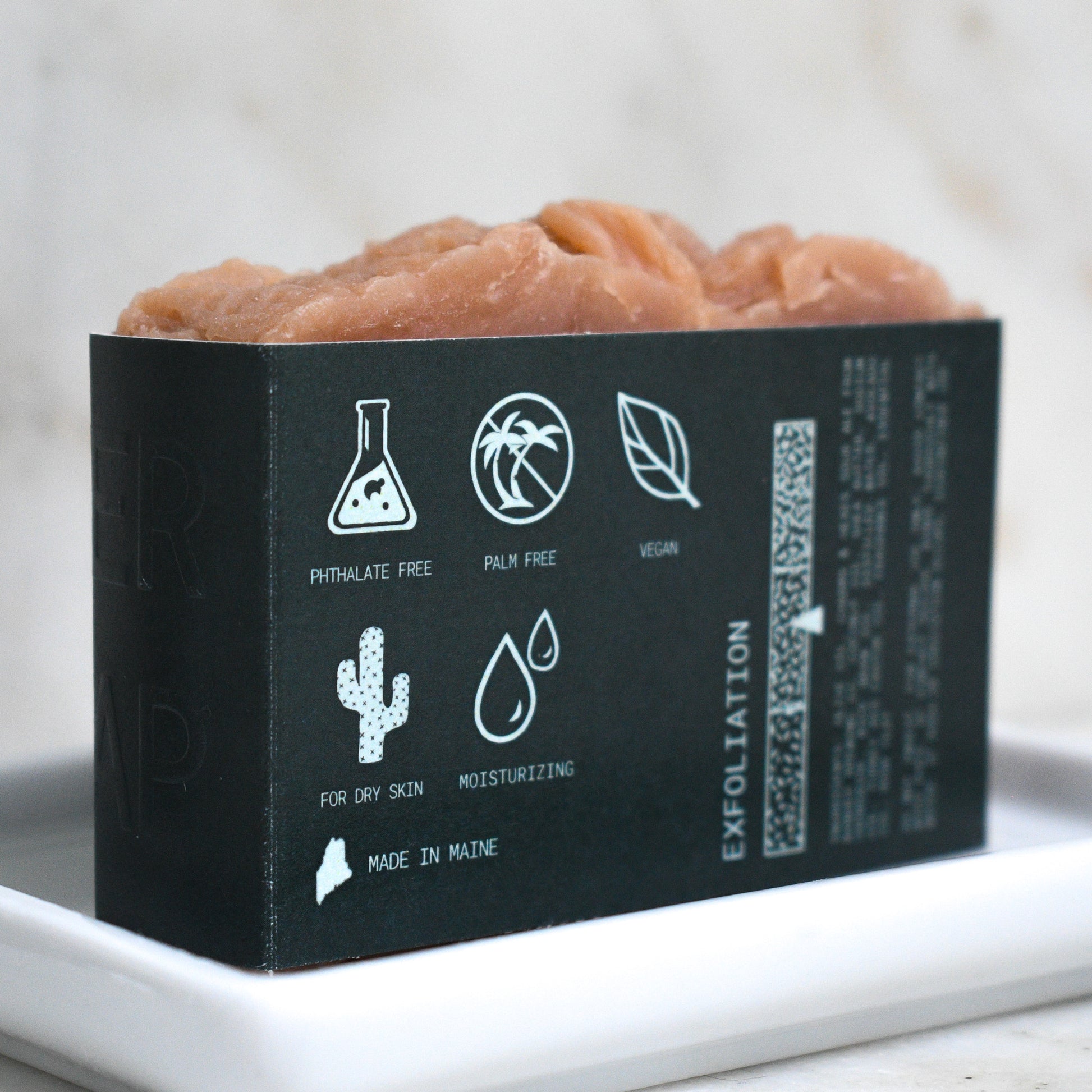 Kettle Rose beer soap on a ceramic soap dish showing on the back label that it is Phthalate free, palm free, vegan, for dry skin, moisturizing, and made in Maine