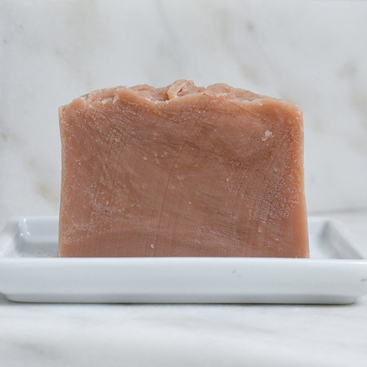 bare bar of Kettle Rose beer soap on a ceramic soap dish