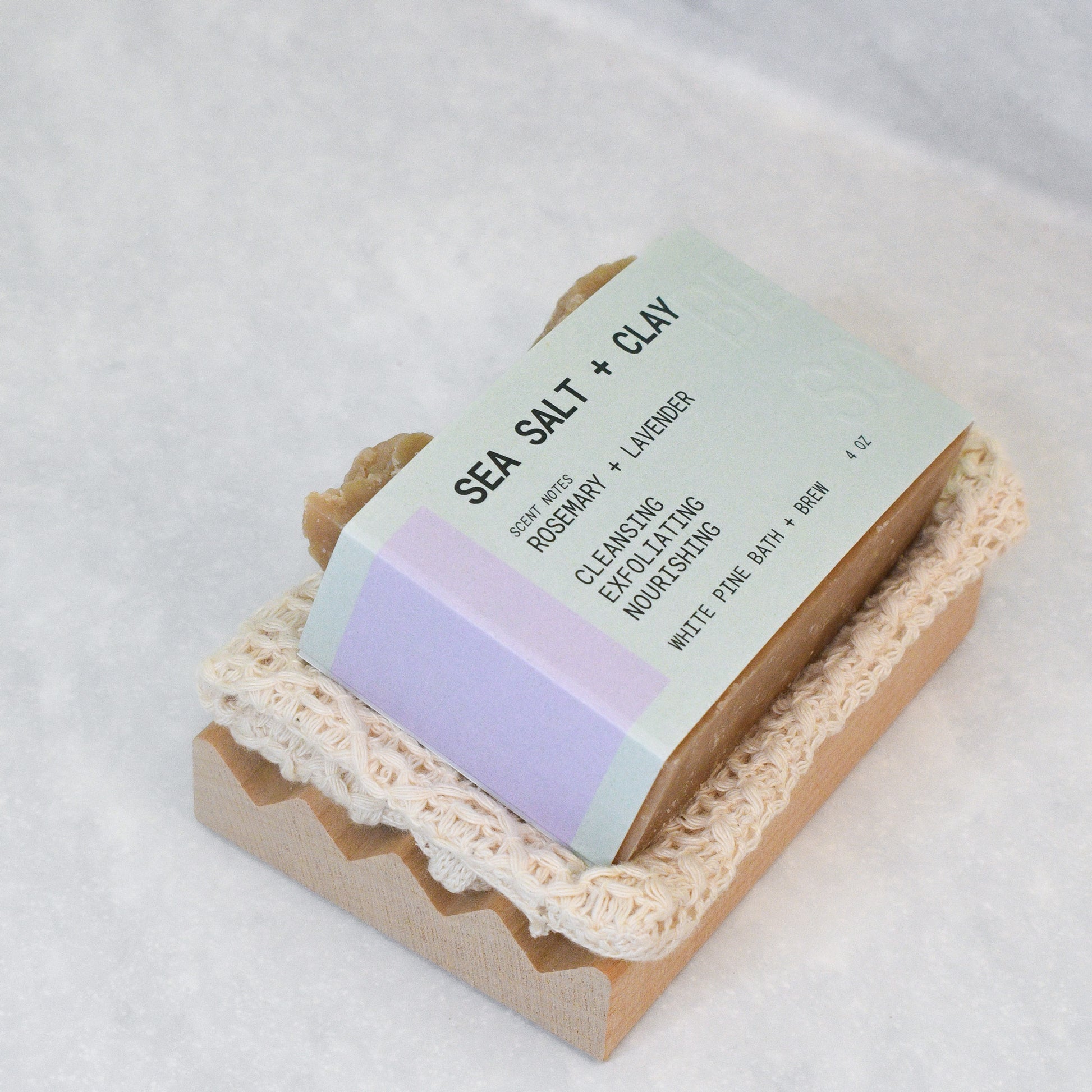 sea salt and clay bar, organic cotton soap saver bag, and wooden soap dish