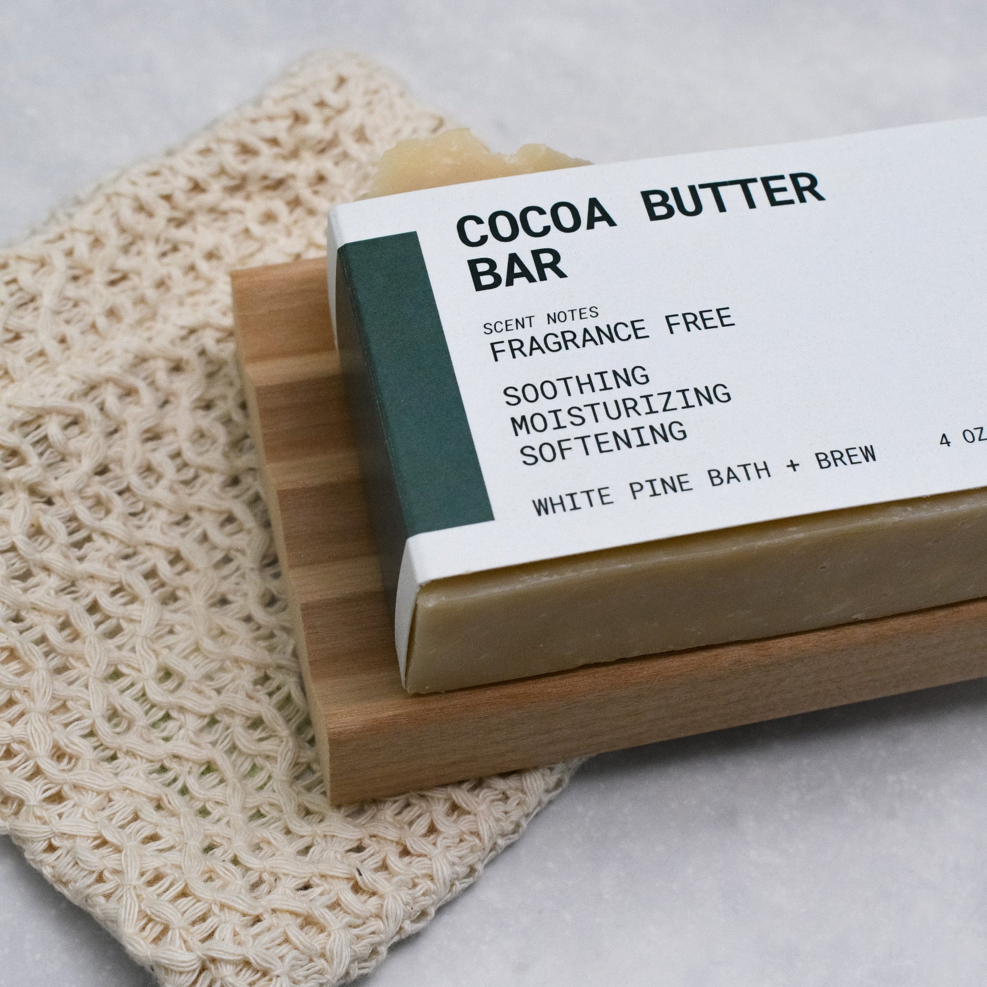 cocoa butter bar, organic cotton soap saver bag, and wooden soap dish