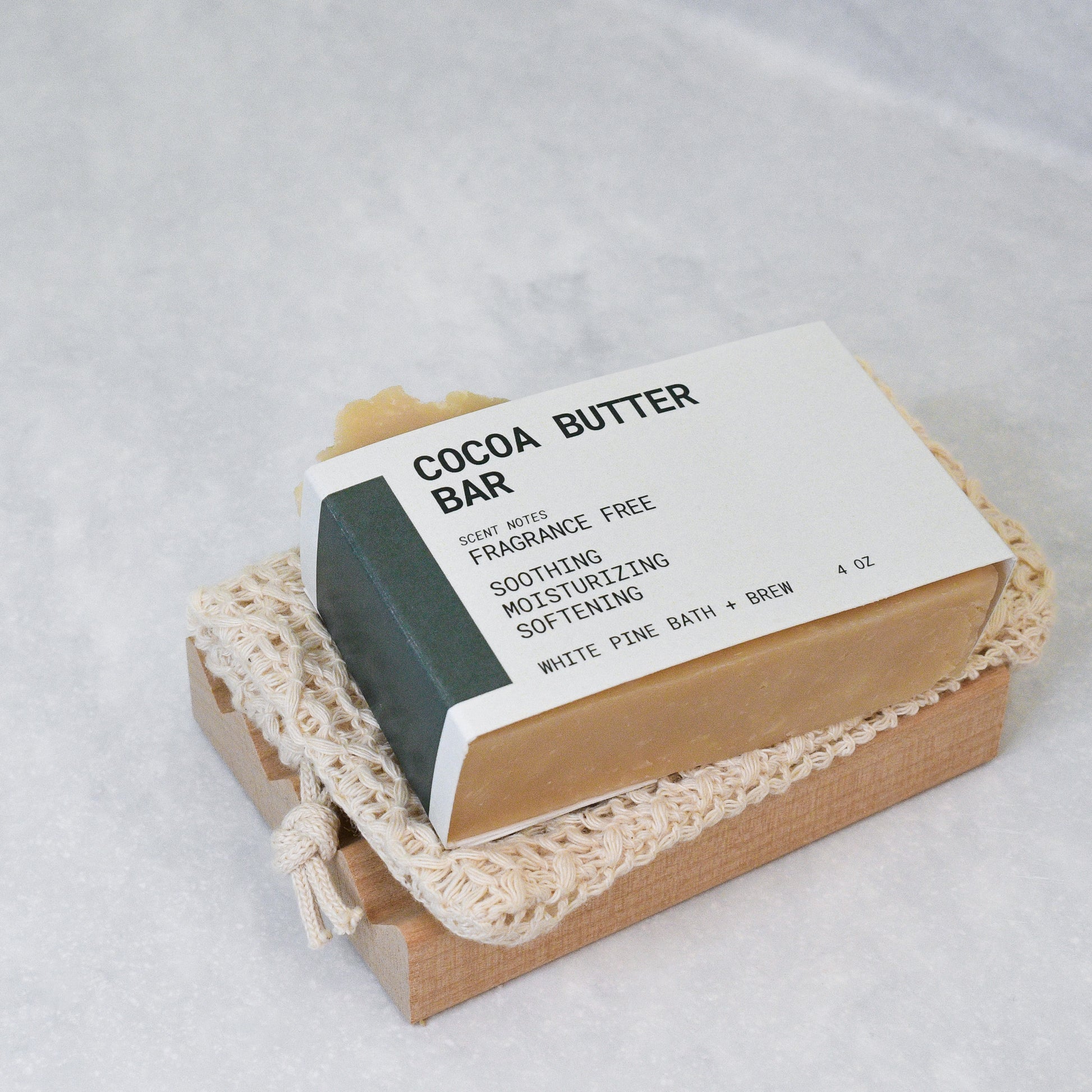 cocoa butter bar, organic cotton soap saver bag, and wooden soap dish