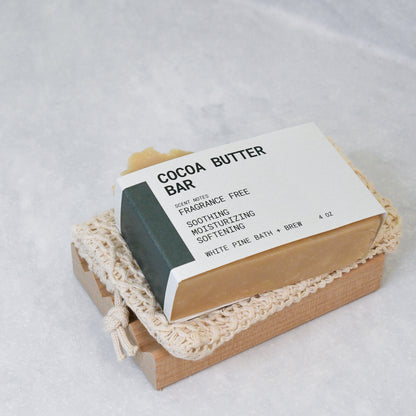 cocoa butter bar, organic cotton soap saver bag, and wooden soap dish