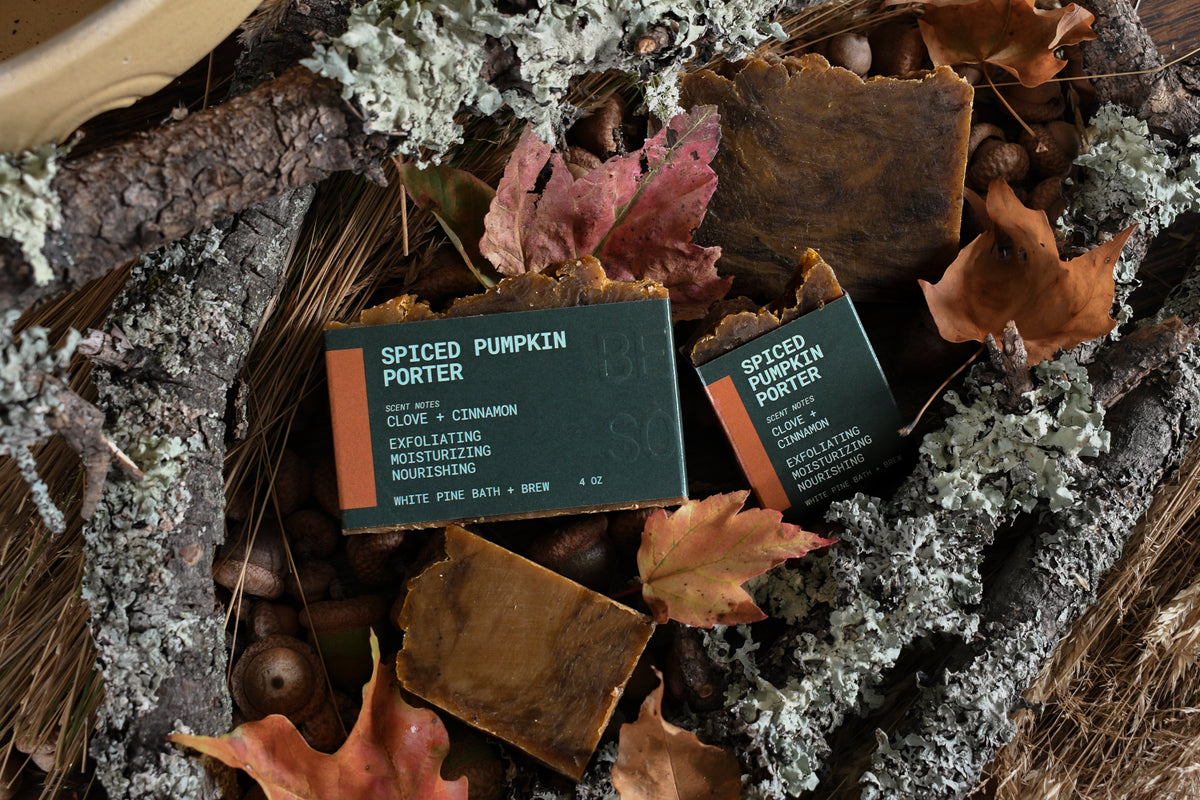 spiced pumpkin porter beer soap among an autumnal bed of colorful leaves, acorns, and branches